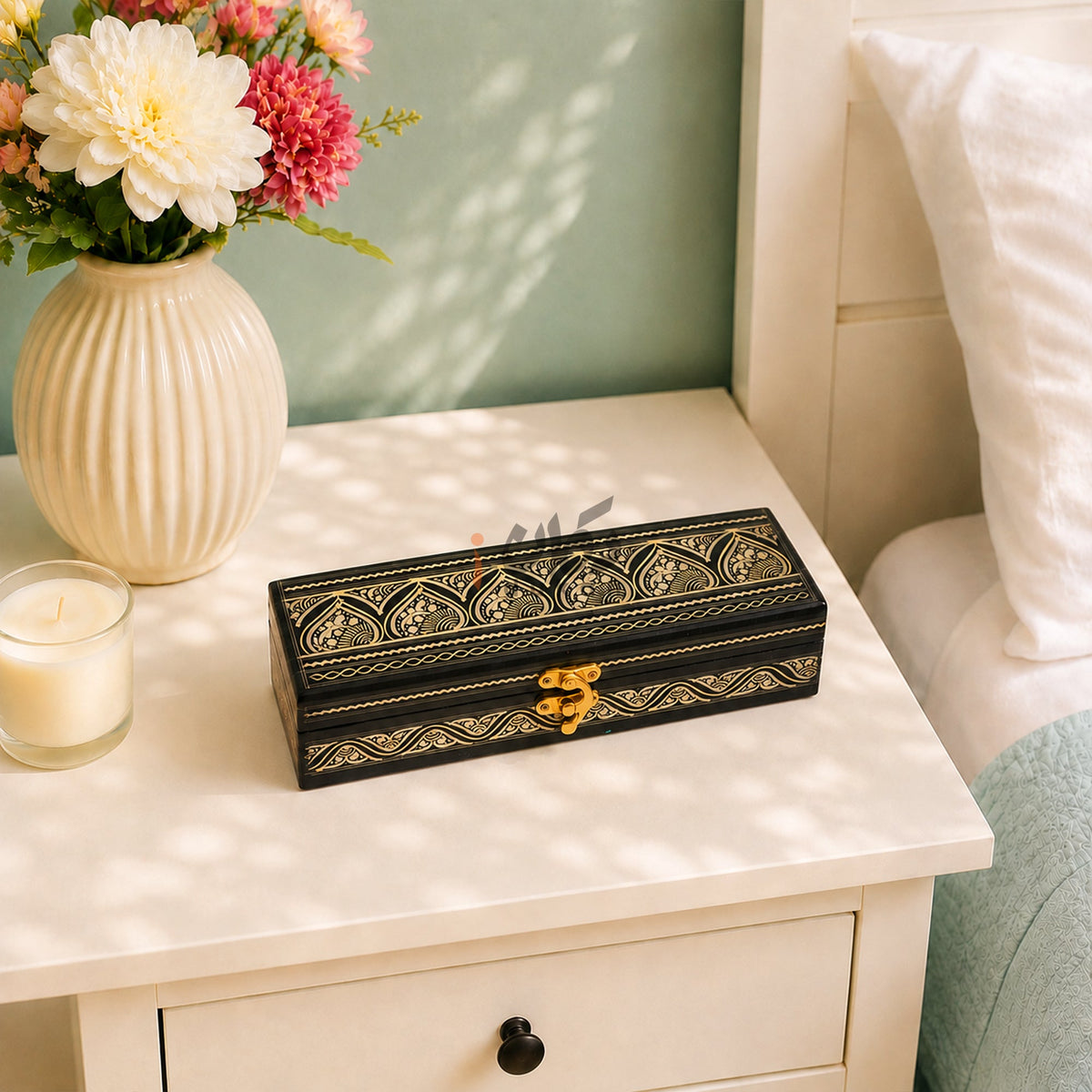 Small Golden black wooden jewelry box on white side table