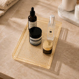 Luxury gold acrylic vanity tray with skincare bottles