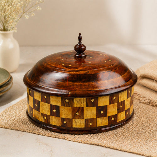 Checkered wooden roti hotpot with brass work on table