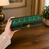 Hands holding small Green carved wooden jewelry box