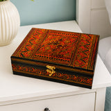 Large red wooden jewelry box on white side table