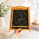Hands holding black marble kail wood serving tray