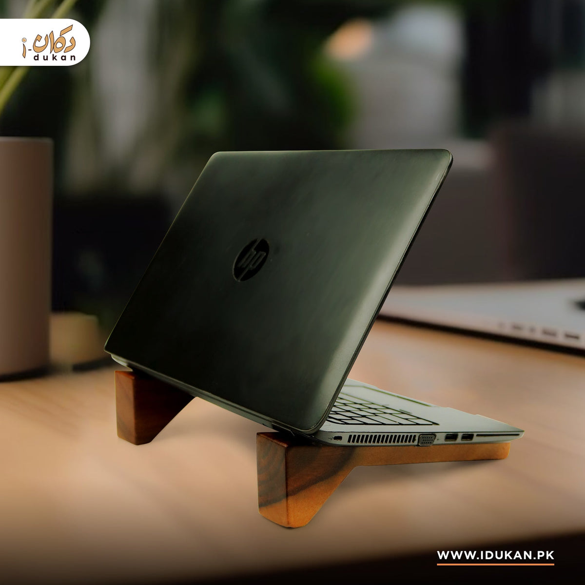 Wooden laptop stand in use on desk