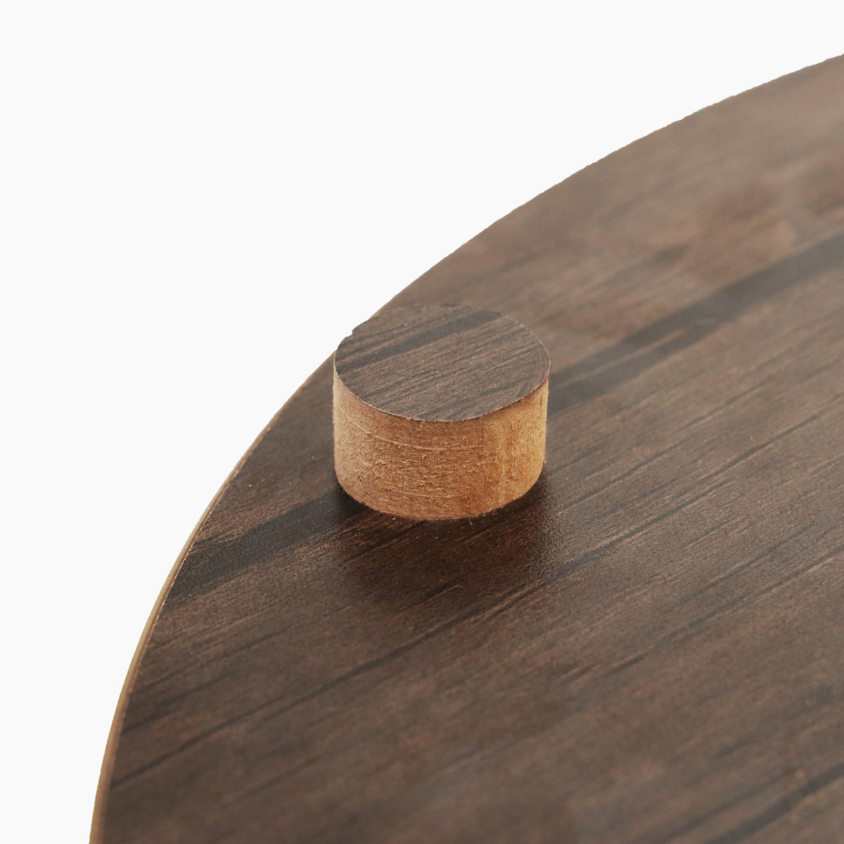 Close up of dark wood top on basket side table