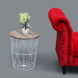 White metal basket side table with wooden top next to sofa