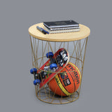 White basket side table used for storage with books