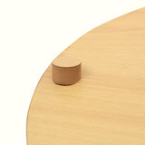 Close up of light wood top on basket side table