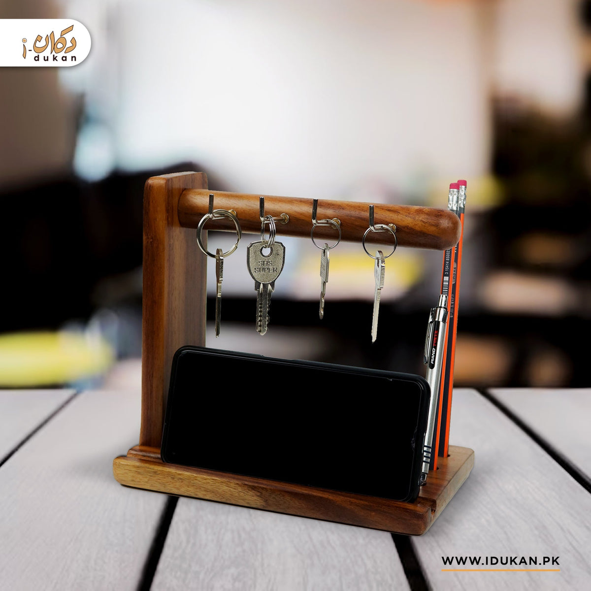 Wooden key holder and phone stand on office desk