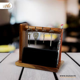 Wooden key holder and phone stand on office desk