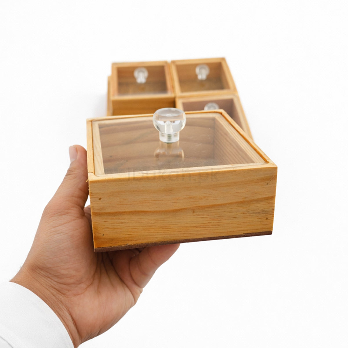 Hand holding wooden storage box with acrylic lid